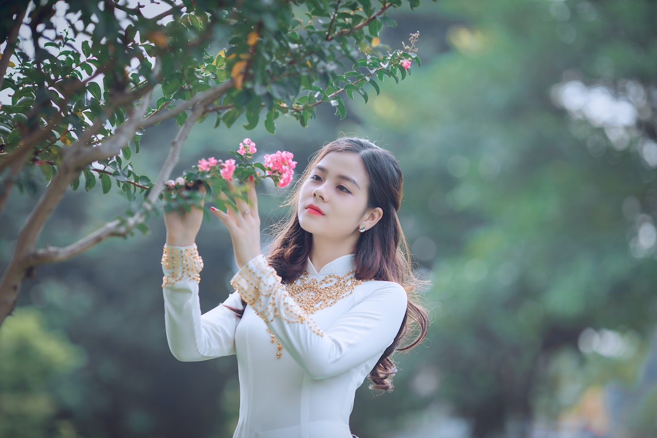 Korean girl touching flower